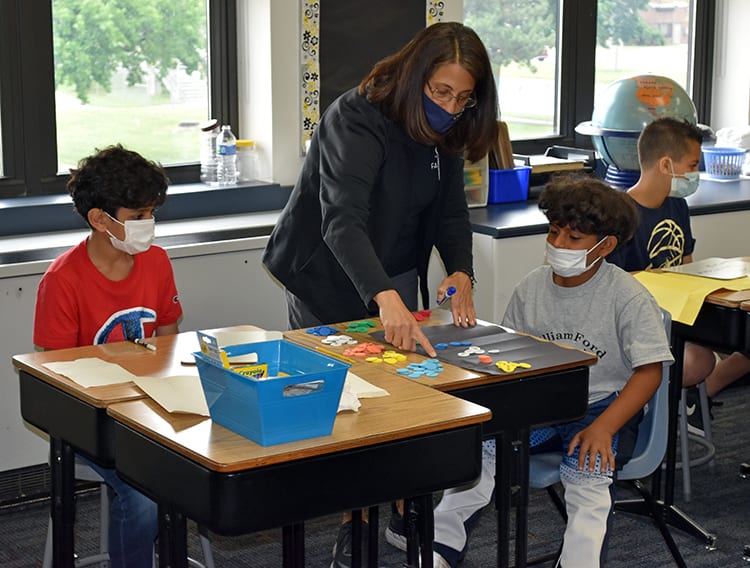 A teacher at William Ford Elementary helps students with a lesson on place values during the first day of the district’s Summer Academic and Enrichment Program on Wednesday, June 23. The district is using federal COVID relief funding to pay for the summer program.