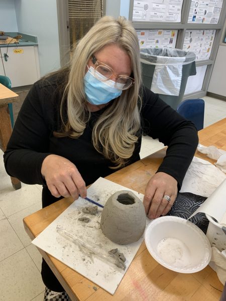 Dearborn Schools art teacher Sunshine Durant works on Tuesday, Nov. 2, on making a clay bowl like the ones that will be given away during the Empty Bowls fundraiser