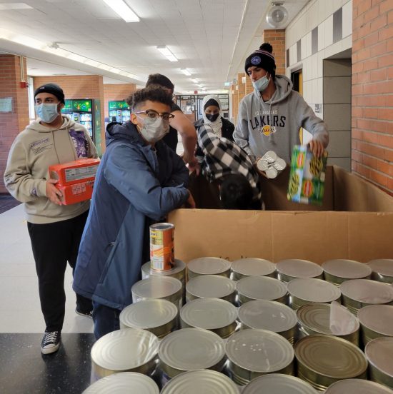 Edsel Ford High School students help pack food collected for the Battle Against Hunger in November 2021.
