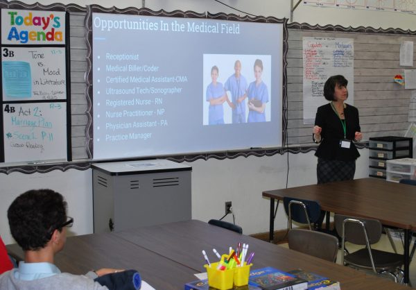 A woman speaks about healthcare careers during a Career Day at Fordson High in 2019.