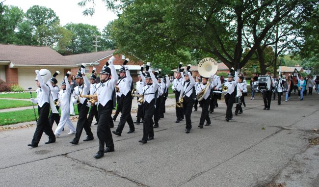 The Edsel Ford High School marching band participates in the 2018 Homecoming parade through the neighborhood.