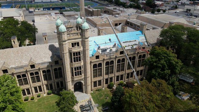 A drone photo shows a large section of roof under repair at Fordson High School.