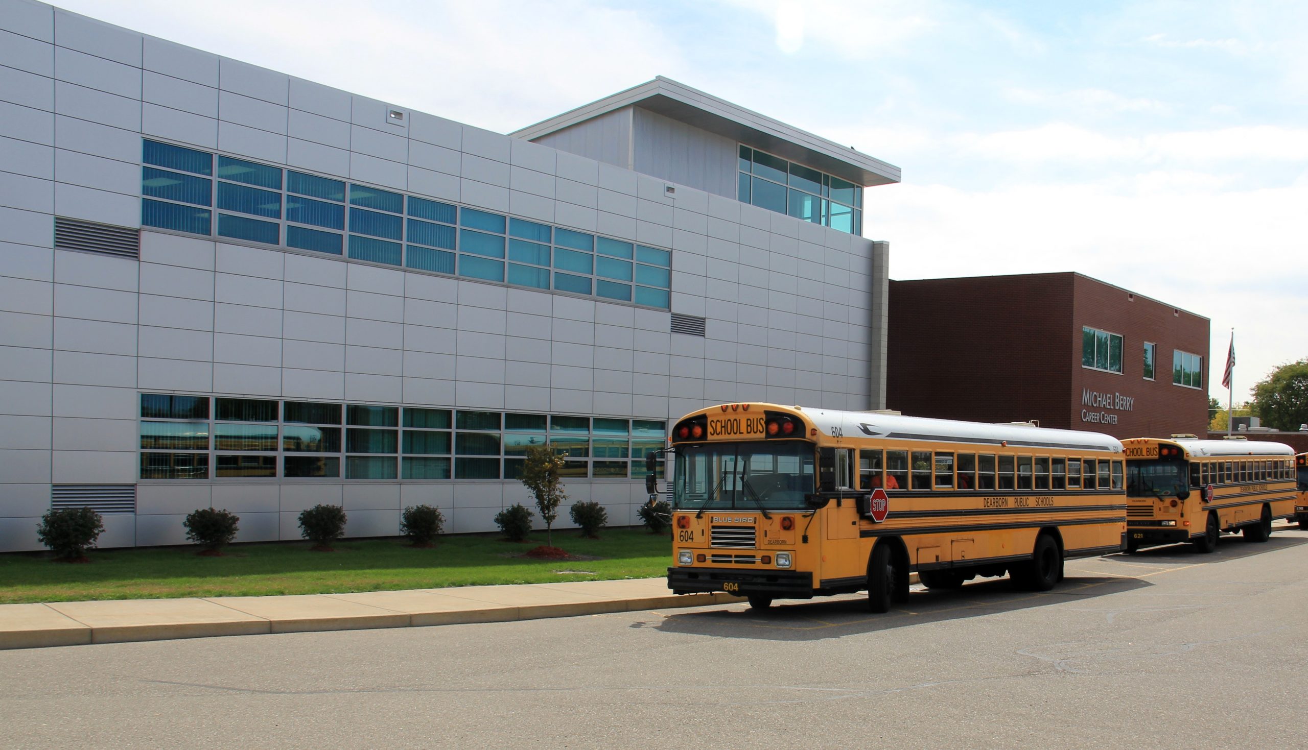 A bus parked in front of the Michael Berry Career Center in Dearborn, Michigan