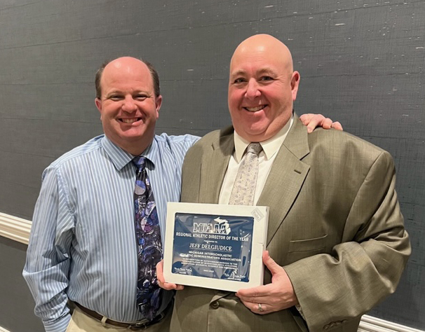 Fordson Athletic Director Jeff DelGiudice poses for a picture with is award and with Dearborn High Athletic Director Jeff Conway.