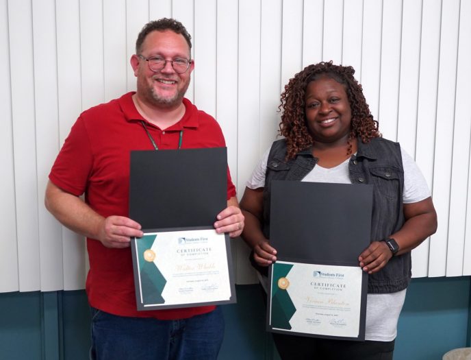 Walter Wheble and Vivian Blanton pose with certificates as they celebrate completing their 12-month building operations specialist/building engineer training with Dearborn Public Schools. Not shown is Tyler Saba, who also completed the program.