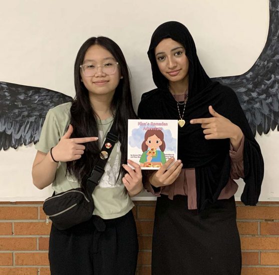 Thao Ho and Jumana Abbas show off a copy of Mina's Ramadan Adventure