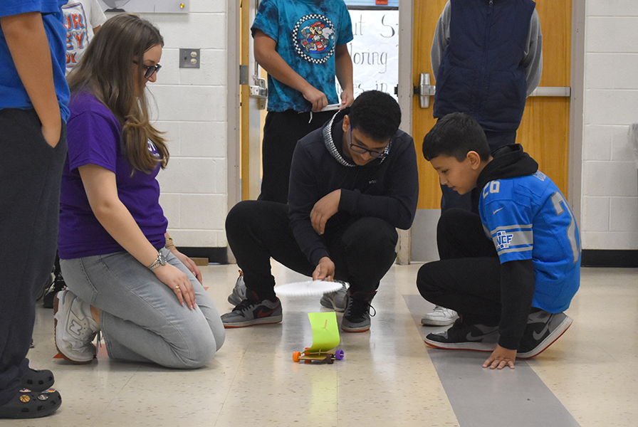 Stout students test out a wind car during a STEM class with guests from the Society of Women Engineers