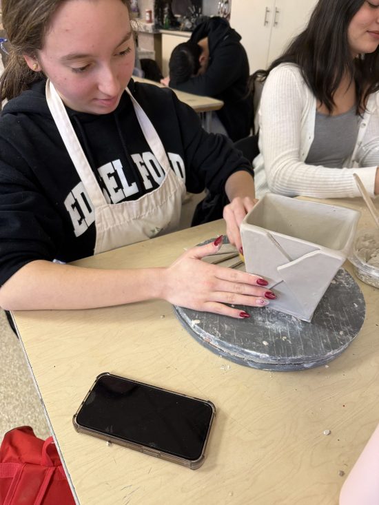 An Edsel Ford student makes a clay sculpture