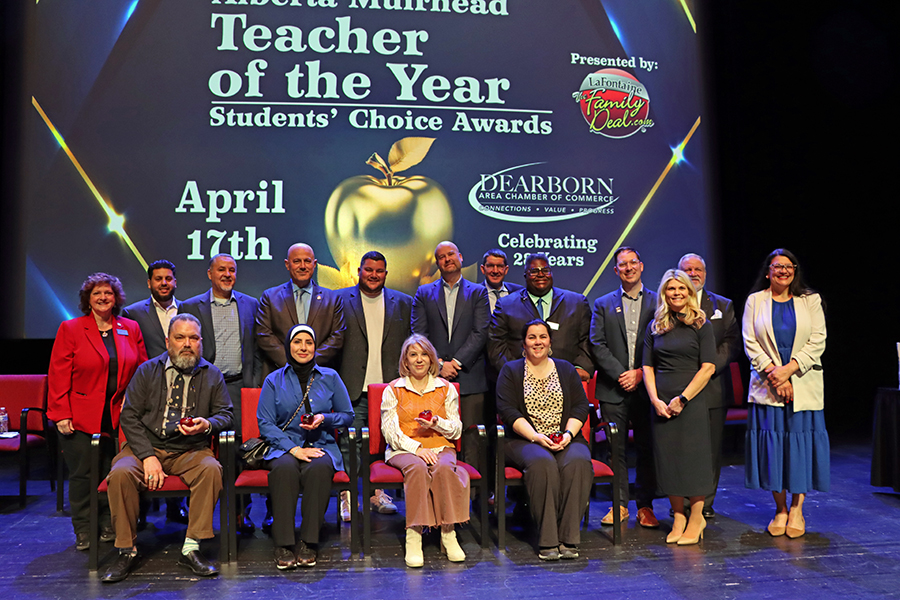 A group of people stand on stage after the 2025 Teacher of the Year Awards presentations