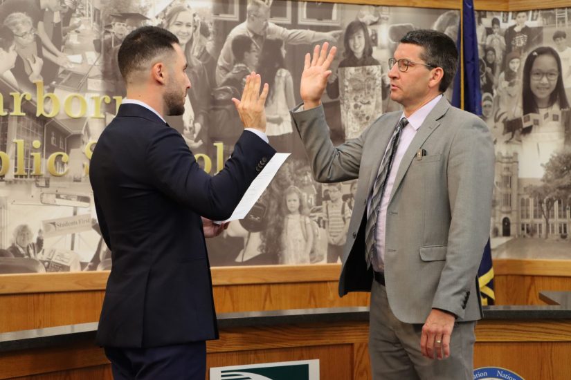 Glenn Maleyko holds up his right hand while taking the oath of office administered by Dearborn Mayor Abdullah Hammoud.