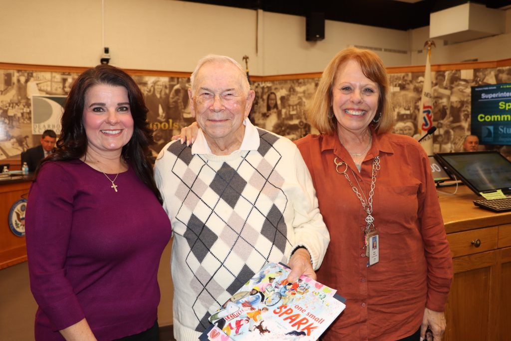 Teacher Kandi-Kay Mehrhof, James Martin, and Principal Sue Stanley pose at a Board of Education meeting.