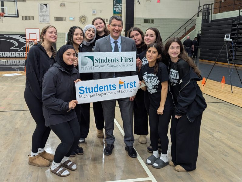 Superintendent Maleyko and a group of students pose with a Dearborn Public Schools sign and a Michigan Department of Education sign.