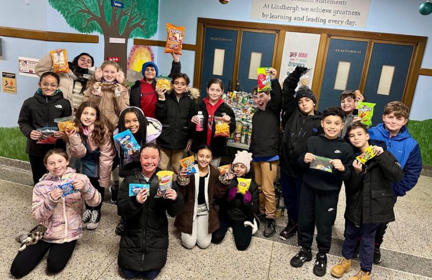 A group of Lindbergh Elementary students show off some of the food collected during the 2024 Battle Against Hunger.