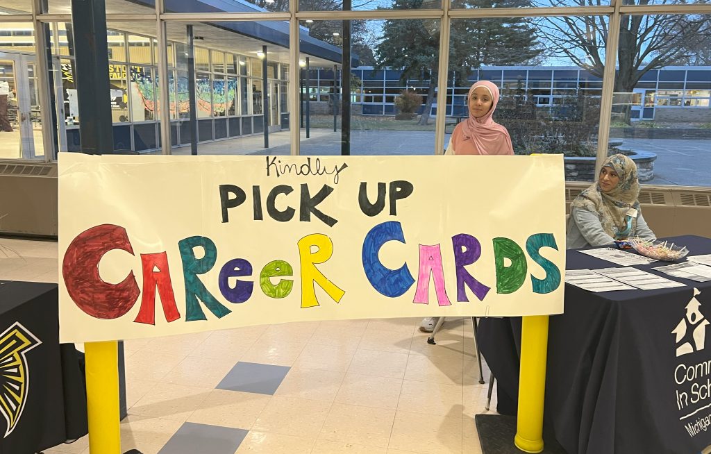 A hand-made sign encourages people to pickup career cards.