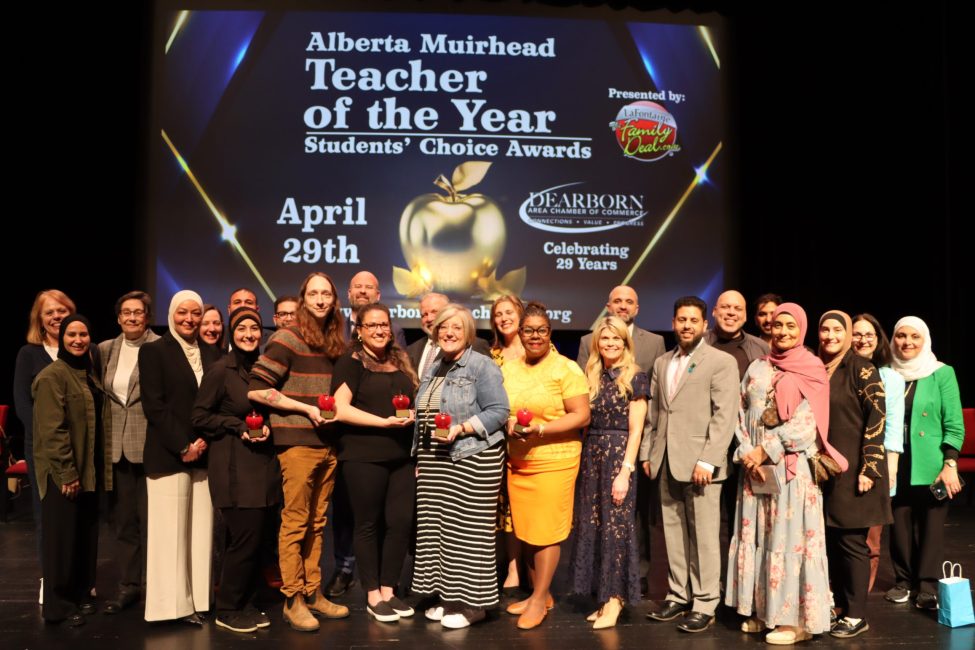 A large group of people stand on stage at the 2026 Teacher of the Year Awards.