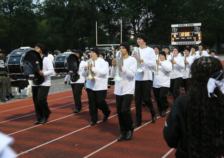 PR 10 Edsel Ford’s marching band plays before the homecoming game Marching band members perform on the sidelines before an Edsel Ford High football game.