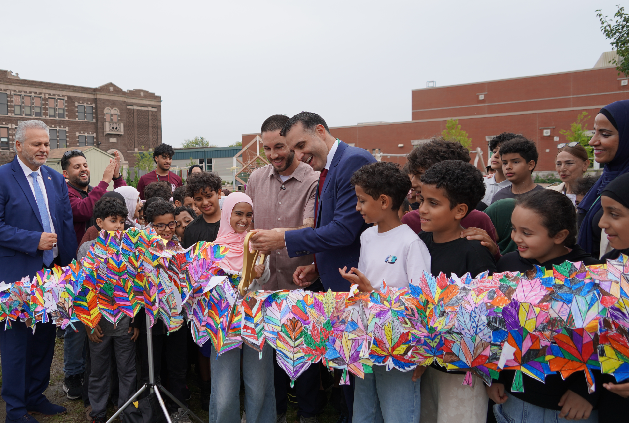 Students, Superintendent Mike Esseily, and Dearborn Mayor Abdullah Hammoud open two new playscapes at the Salina Schools campus with a ribbon cutting ceremony on Wednesday, Sept. 16, 2026.