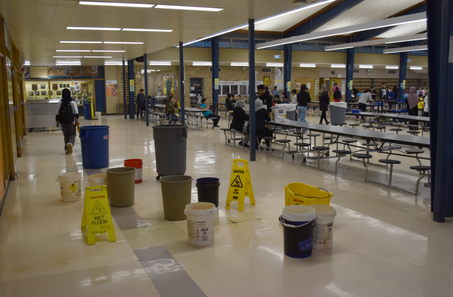 Buckets and wet floor signs fill a section of the Stout cafeteria